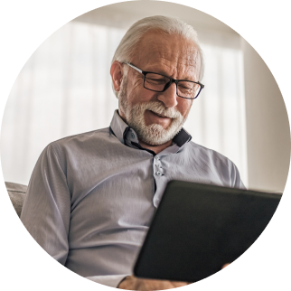 Old man watching his laptop